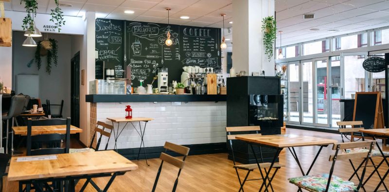 Empty modern cafe interior with chairs and tables